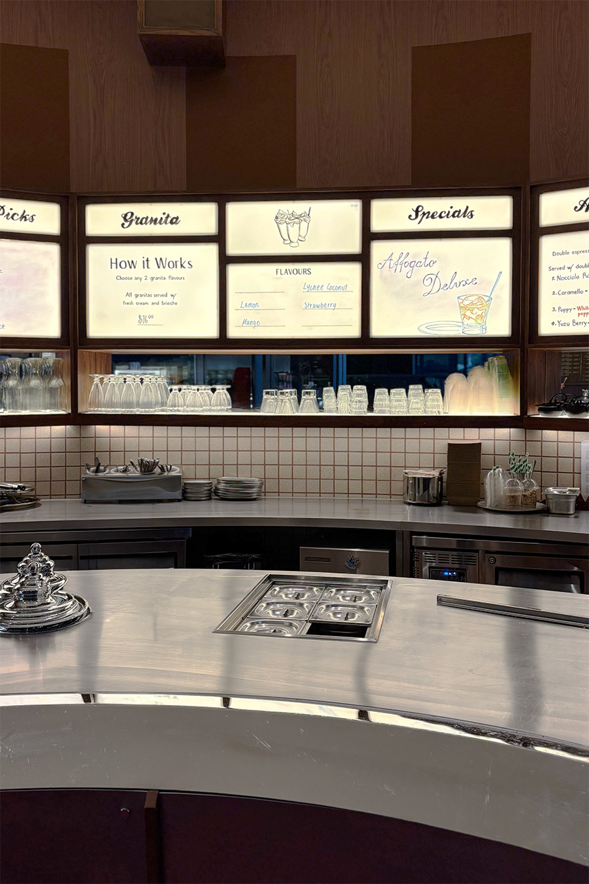 Backlit menu boards over the servery at Cow and The Moon