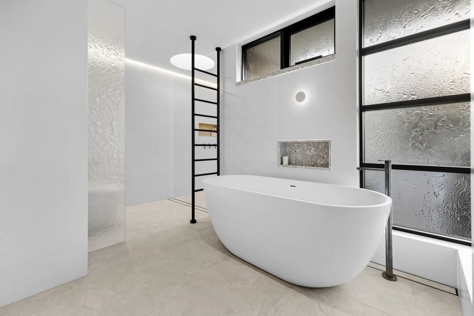 Main bathroom with freestanding tub and textured glazing