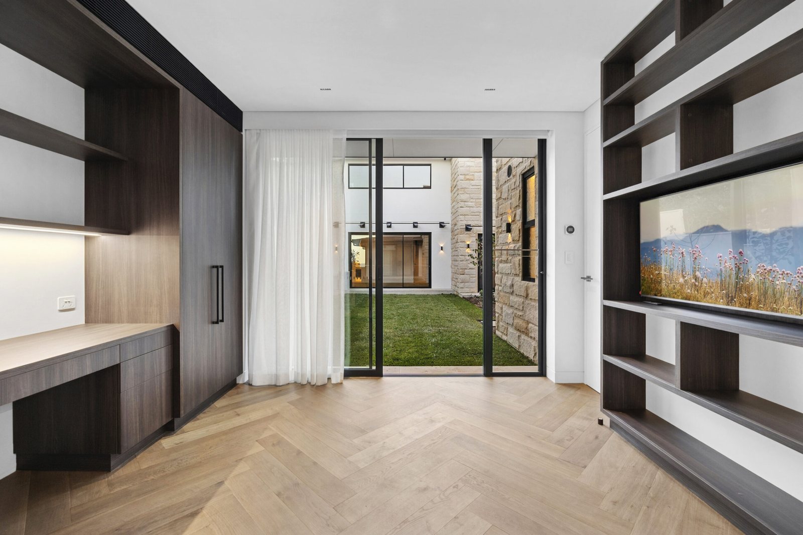Living room in herringbone oak looking through to the sandstone courtyard