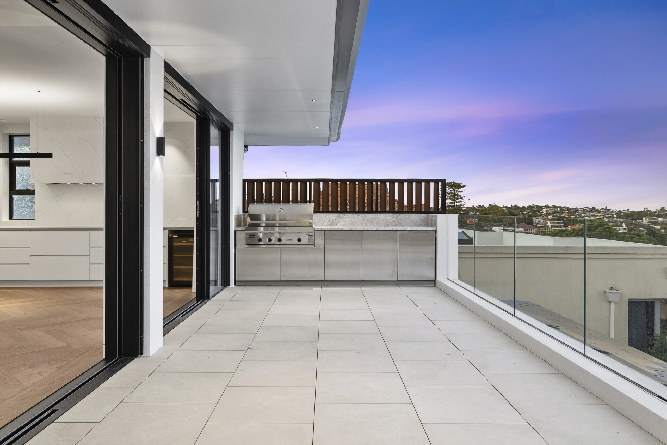 Finished terrace with outdoor kitchen at dusk after the final clean and pressure wash